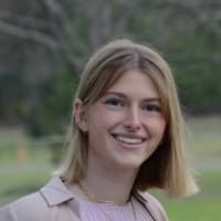 Female student outdoors smiling for a picture